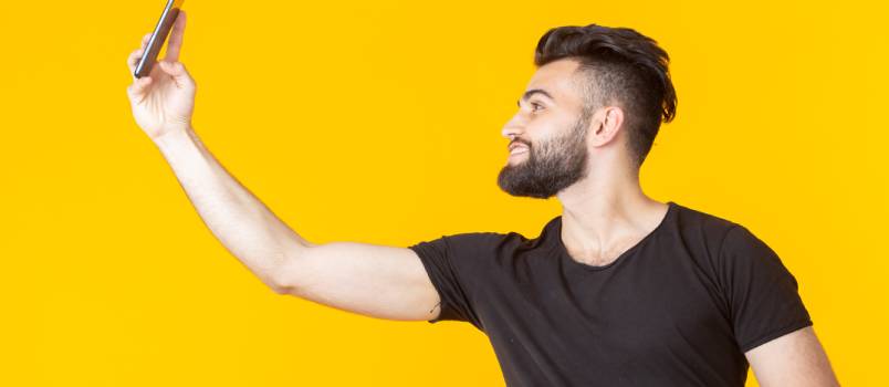 Handsome man taking selfie