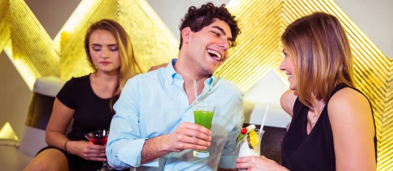 Sad woman sitting with happy couple