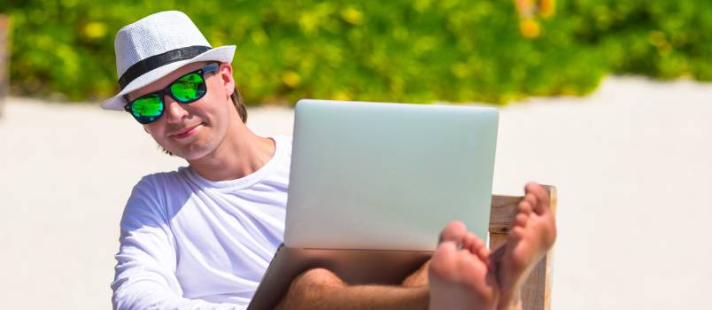 Man on vacation using laptop