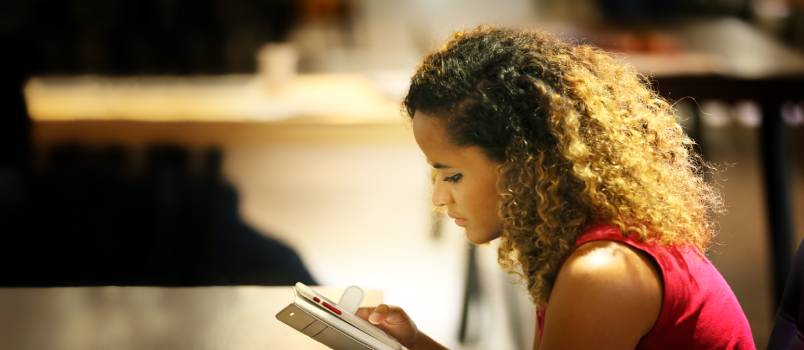 Woman using phone in cafe
