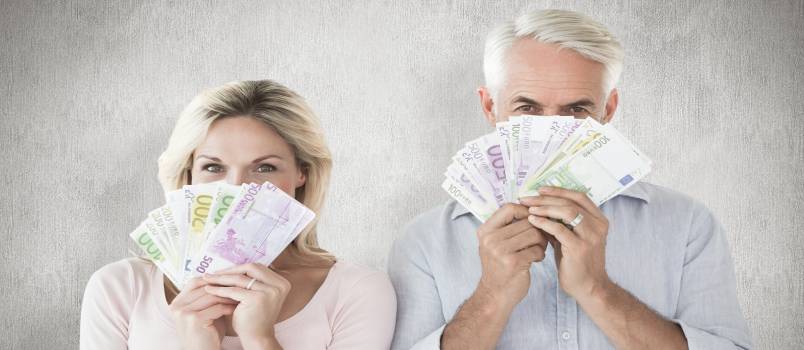 Happy couple flashing cash