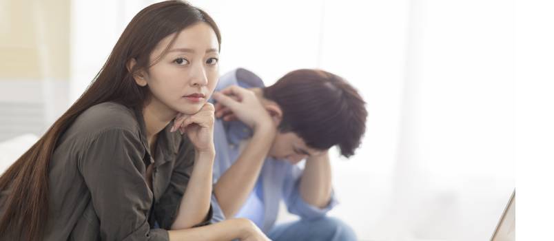 Upset couple using laptop