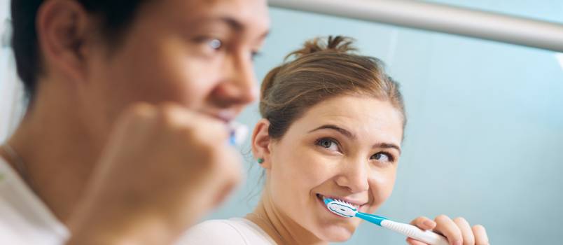 Couple brushing together