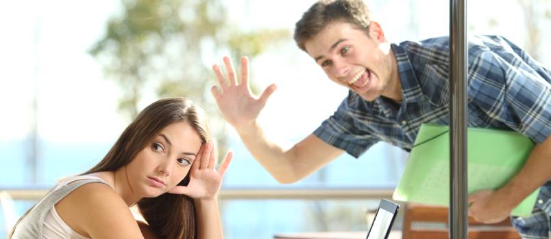 Girl ignoring rejecting stalker man waving 