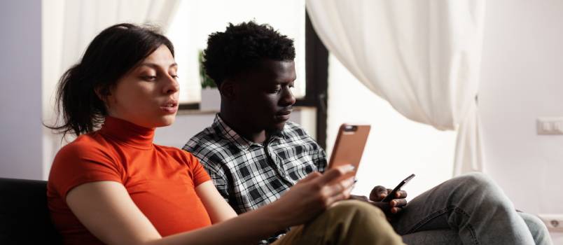 Relaxing couple using smartphone