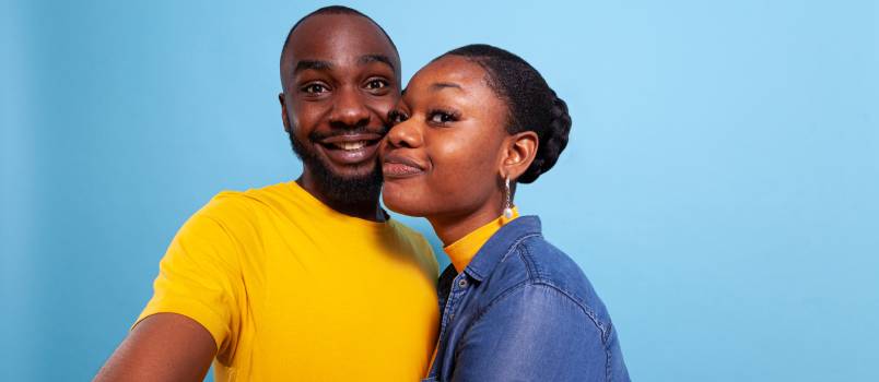 Couple smiling in from of camera