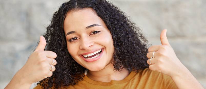 Happy woman showing thumbs up