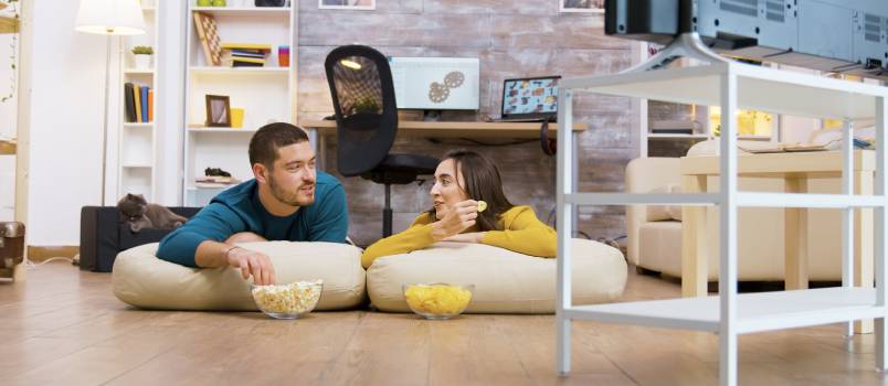 Couple talking while watching television
