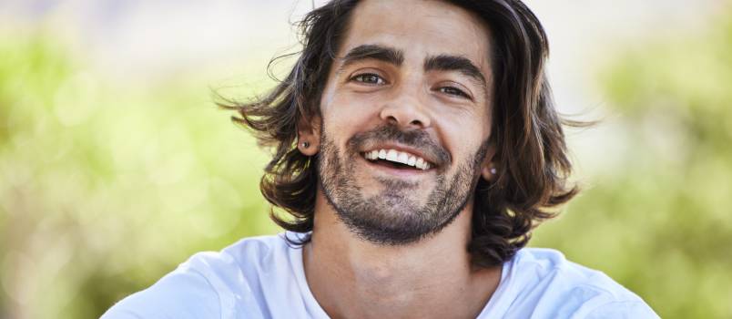 Man smiling outside in the park
