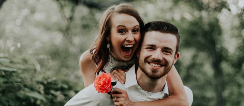 Woman riding on mans back