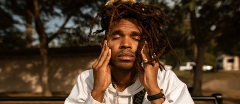 Stressed man touching his face