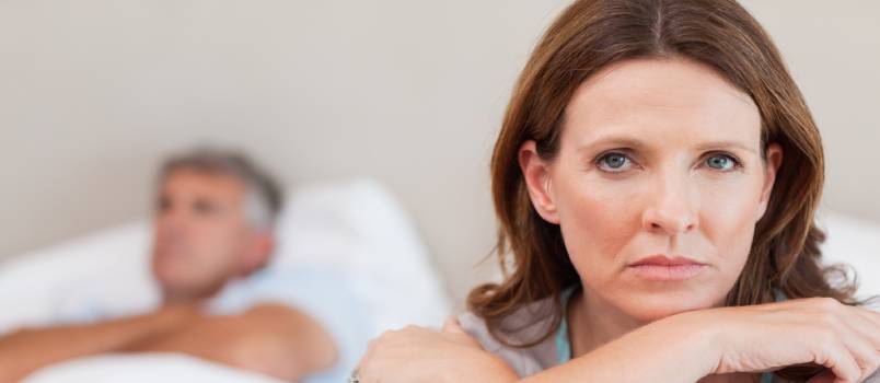 Sad woman on bed with husband