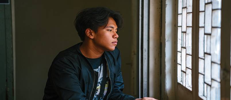 Man sitting beside window