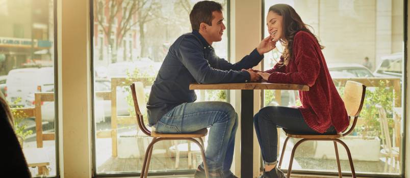 Couple having romance in café