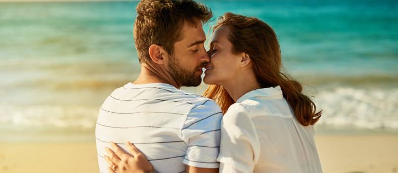 Couple kissing at beach side