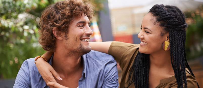 Affectionate young couple sitting outside 