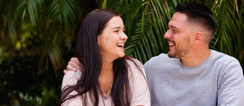 Young couple sitting outside together