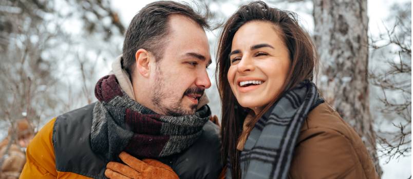Young couple in snowy forest