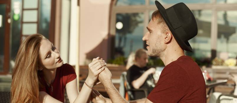 Couple sitting cafe looking at each other