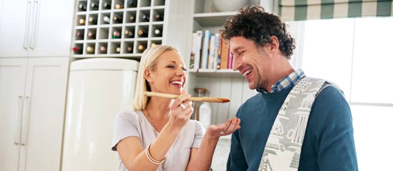 Couple cooking together in kitchen