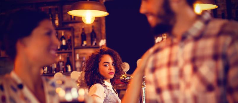 Jealous woman looking at flirting couple