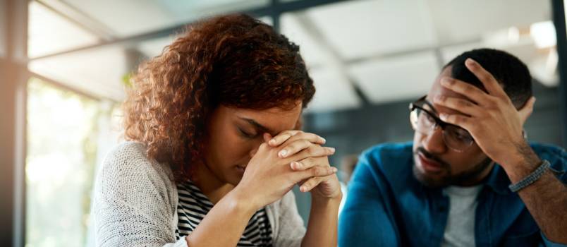 Stressed couple working on budget