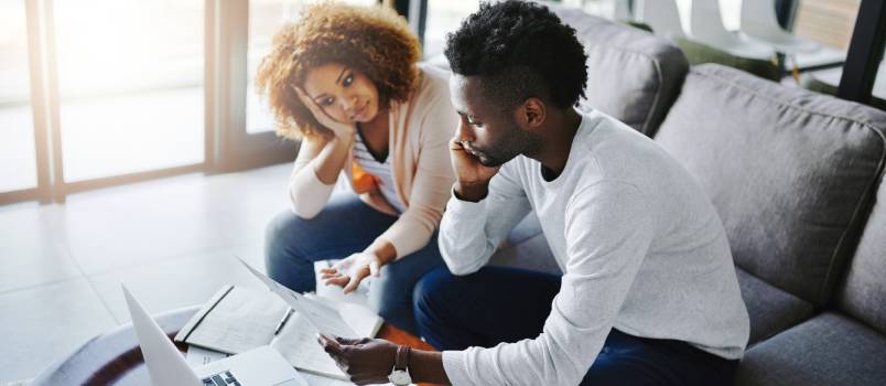 Couple calculating monthly budget