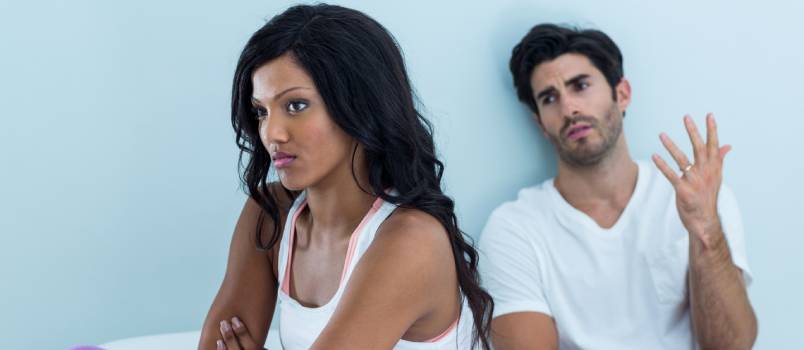 young people arguing on bed