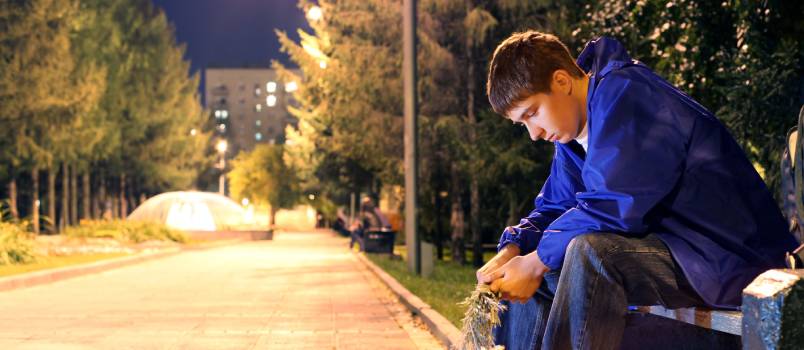 Unsuccessful young boy sitting alone