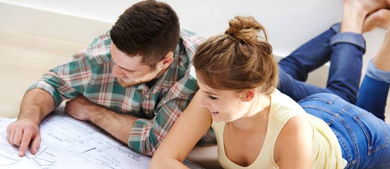 Couple inspecting building plan