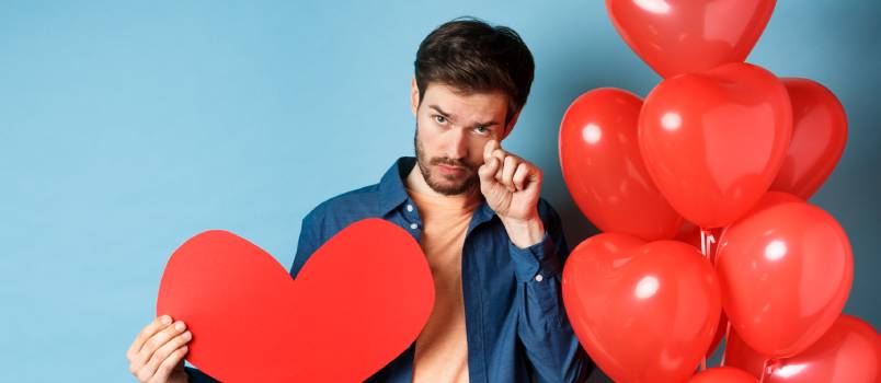 Man crying with red heart and balloons