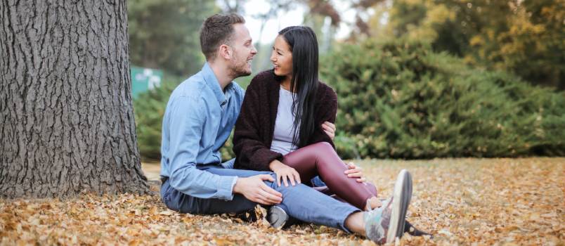 Couple sitting under tree