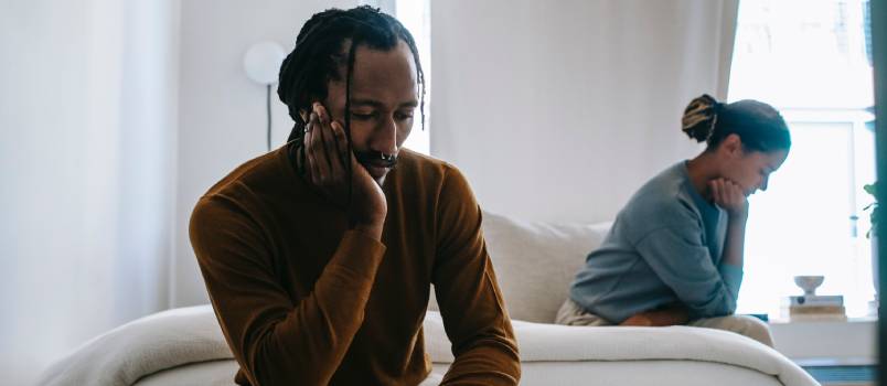 Upset couple sitting apart at home