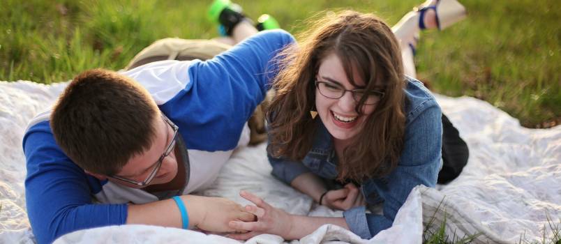 Couple laying on white mat