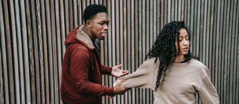 Aggressive man grabbing woman