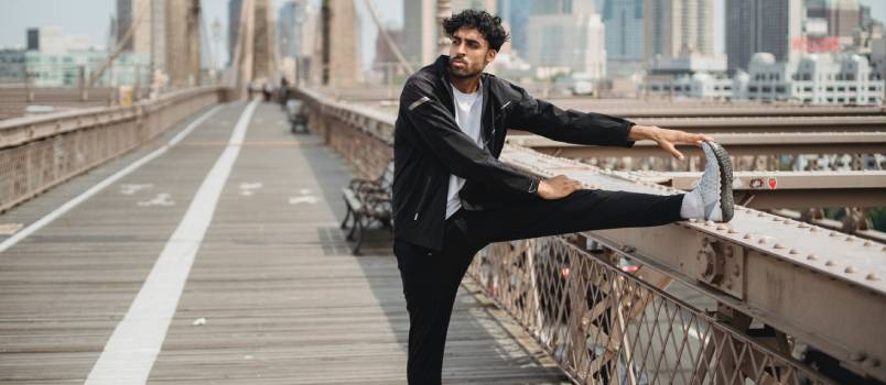 Man doing stretching on bridge