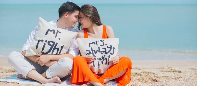 Man and woman sitting near the beach