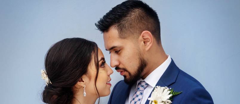 Bride and groom standing next to each other