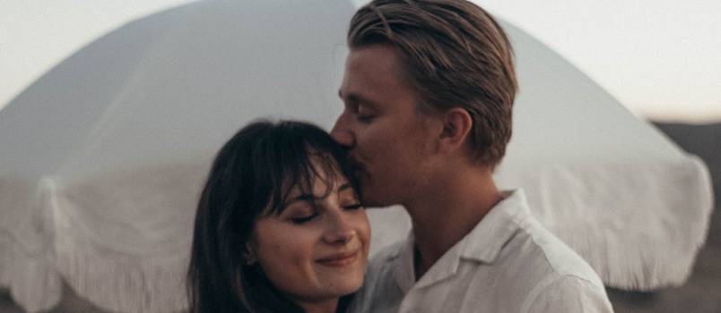 Man kissing woman on forehead