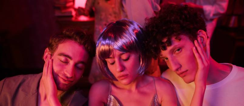 Drunk woman sitting between two man