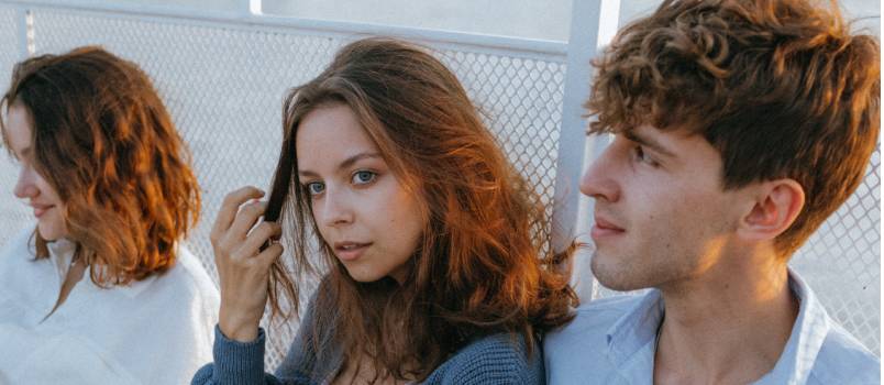 Couple sitting on railing