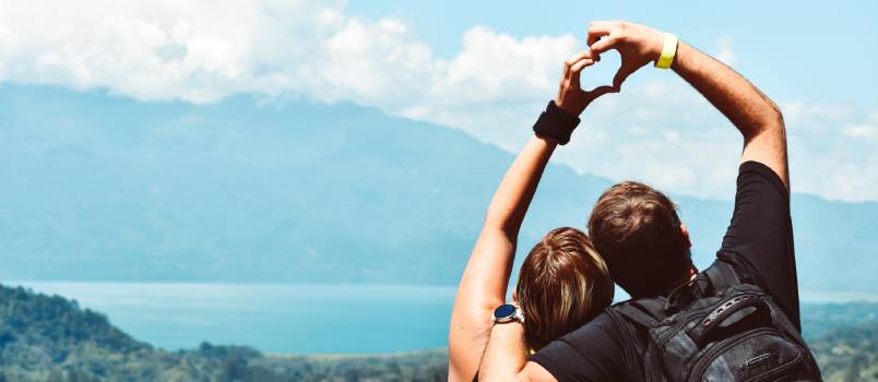 Two people formatting heart from hand