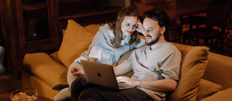 Loving couple using laptop