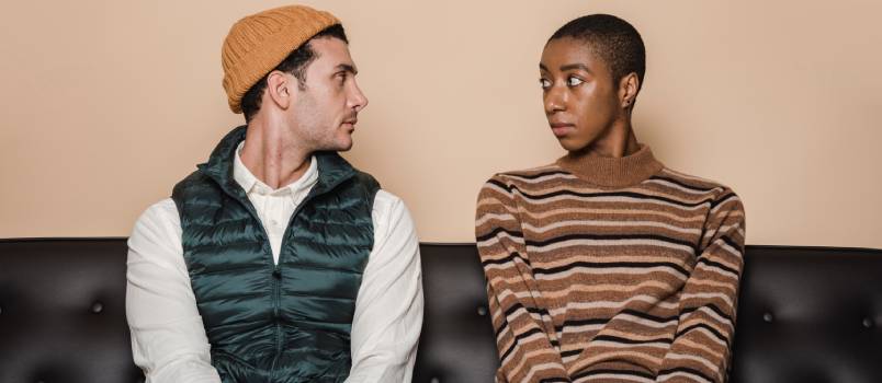 Unhappy couple sitting on sofa