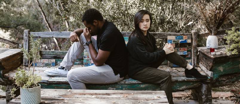 Upset couple sitting on bench