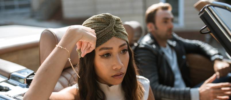 Woman sitting in a car feeling annoyed