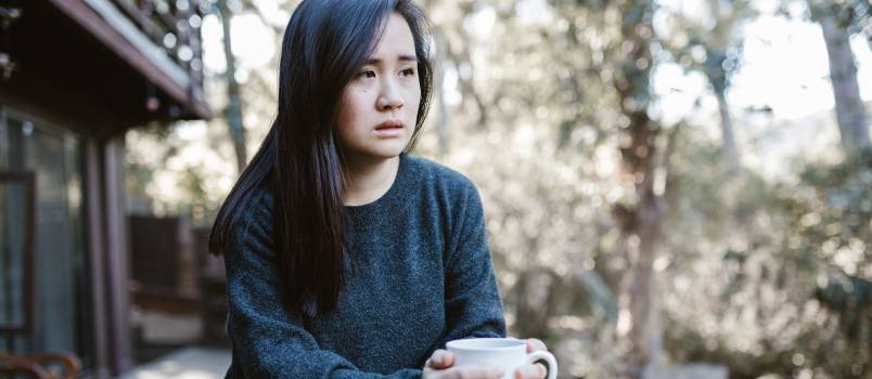 Sad woman having coffee