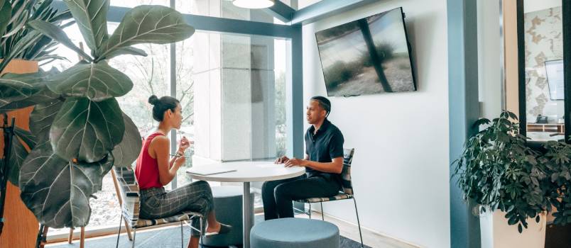 Couple sitting looking at each other