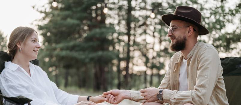 Couple holding hands while sitting