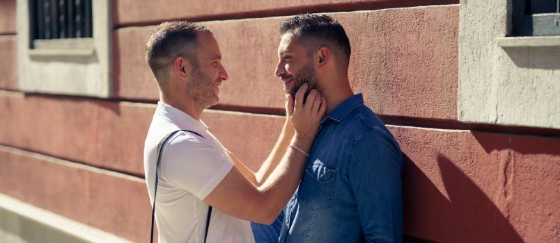 Gay couple smiling looking at each other